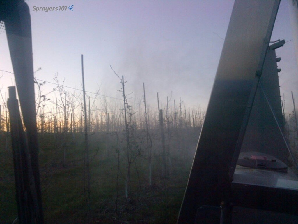 Taken with the sprayer operator’s smart phone, here’s the over-the-shoulder view of an early-morning spray application from the cab. You can’t see coverage, but gaps in the spray will show if nozzles are plugged. You can also check to see if you are overshooting or blowing through the target. Photo Credit – C. Hedges, ON.