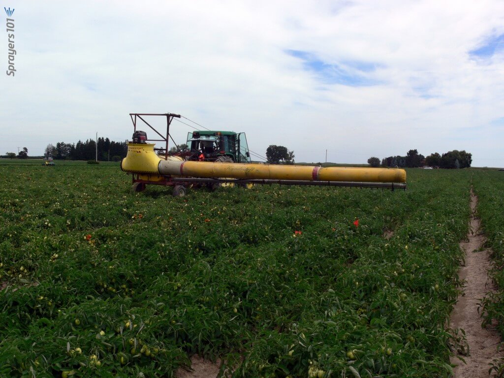 Boom sprayer with air assist sleeve operating.
