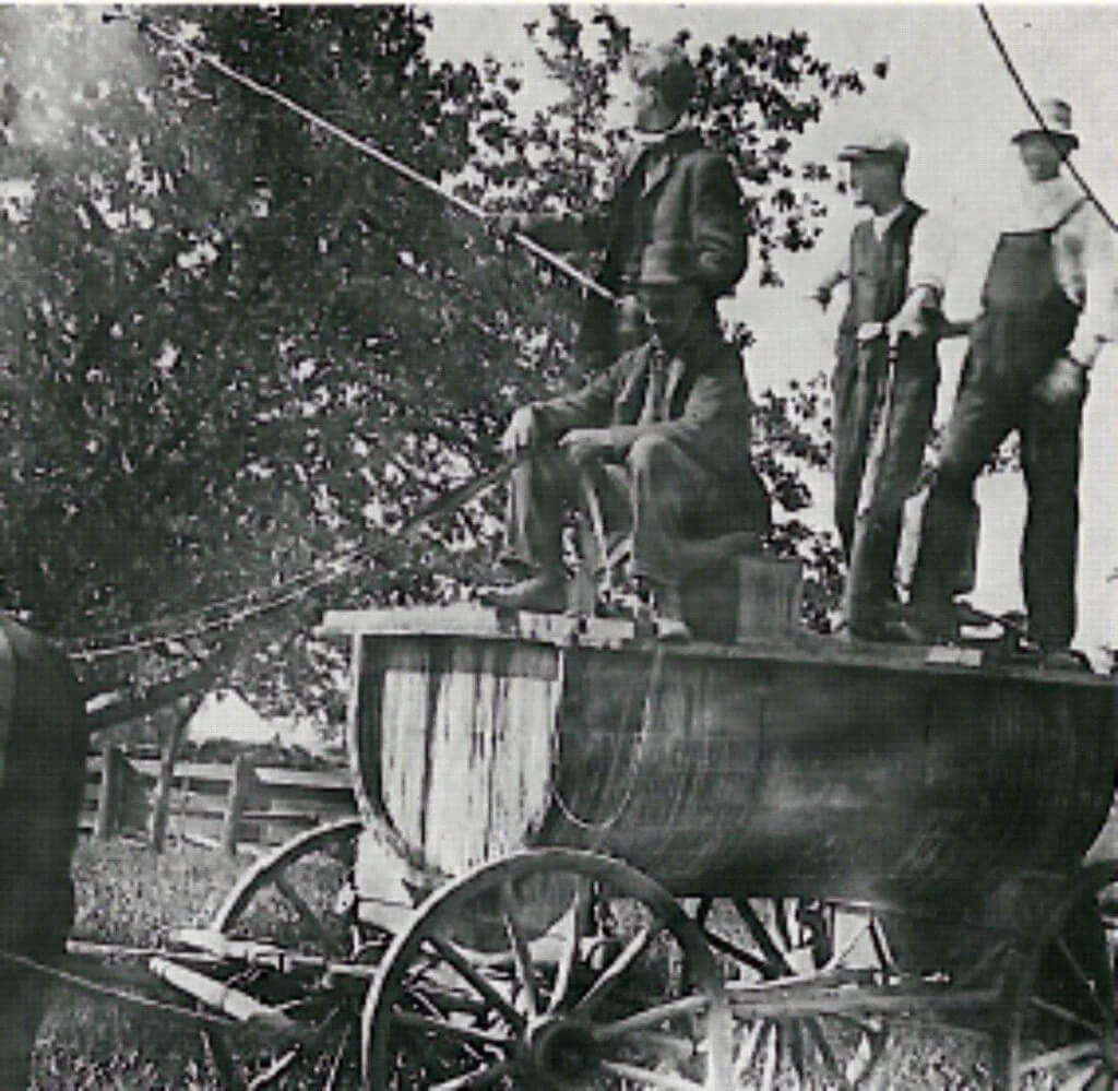 An Ontario orchard spray crew c.1910. Pump pressure was maintained by the two operators at the right. The spraying rate by the above method could cover 1.2 to 1.6 hectares (3 to 4 acres) per hour. Image from www.farms.com